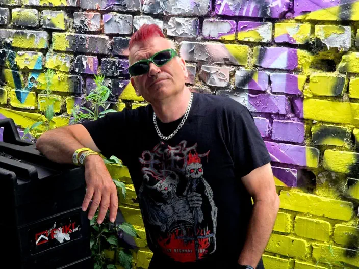 Spike leaning against a wall